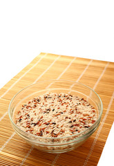 Raw rice in bowl isolated on white