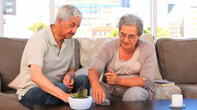 Elderly couple playing cards