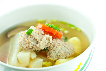 Vegetable soup with pork in white bowl