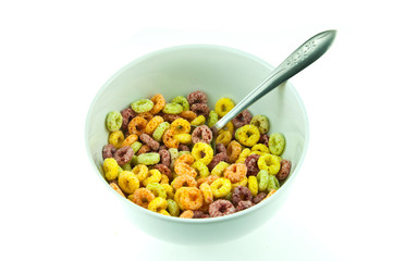 Bowl and spoon with corn flakes on the white background