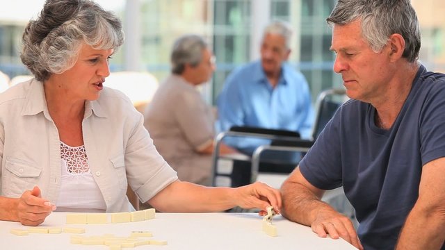 Mature couple playing dominos
