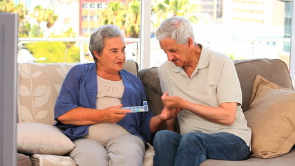 Couple with their pills box - Powered by Adobe