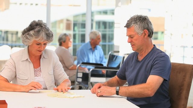 Retired couple playing dominos