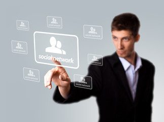 Businessman hand pressing Social network sign