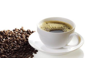 Cup of coffee with coffee seeds on the white background