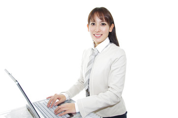 パソコンで仕事中の笑顔のオフィスレディー