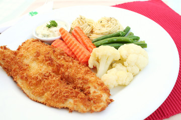 Deep fried fish fillet with vegetables and mashed potato.