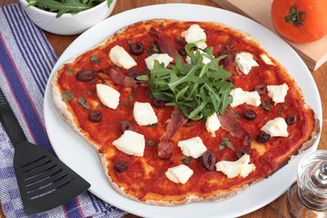 Pizza with ricotta cheese, olives and rocket salad
