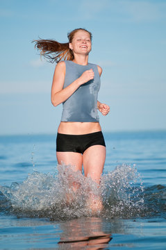 Sport woman running in water