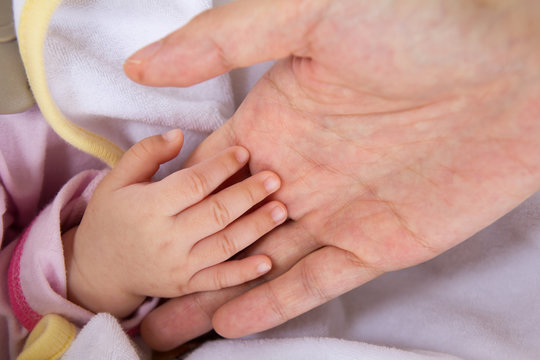 Baby hand in mother's palm