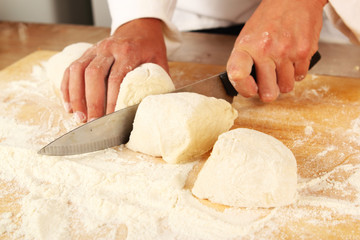Chef cutting dough