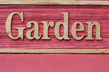 Red wooded garden sign