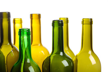 Many empty green wine bottles isolated on white background
