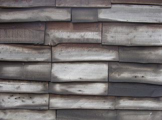 typical timber fence wall made of irregular wooden planks