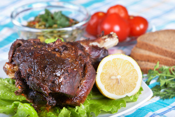 Roast leg of lamb on decorated table