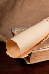 Old paper scroll and vintage book