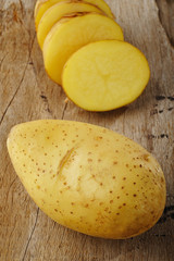 fresh potato on wood background