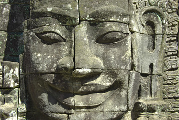 Stone head on towers of Bayon temple in Angkor Thom