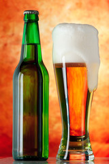 Bottle glass of beer on a yellow background
