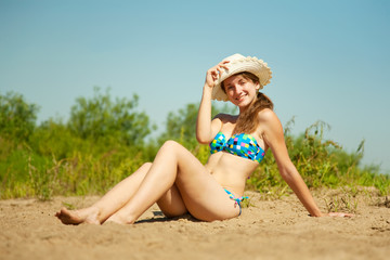 girl  sunbathing on beach