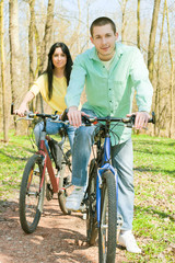 young man and woman on bike outdoors