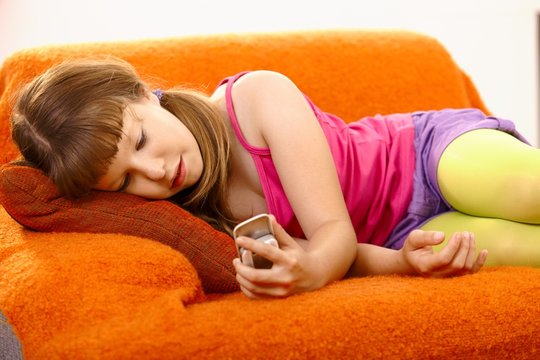 Young girl looking at mobile phone