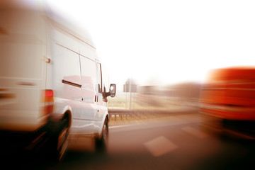 Trucks, delivery vans on freeway. Logistics