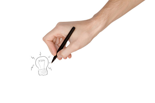 Man's hand drowing a light bulb, isolated on white