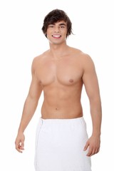 Handsome, happy young man with the towel.