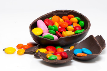 easter chocolate egg and sweets on a light background