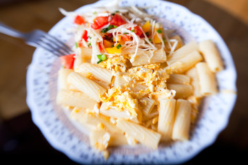 Pasta with salad from tomato and cabbage