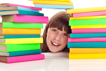 student behind pile of books