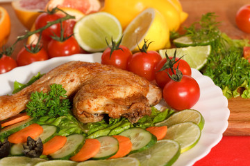 Fried chicken leg with lemon and cucumber