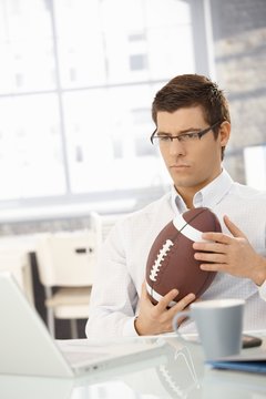 Determined businessman in office with football