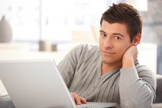 Portrait of handsome young man with computer