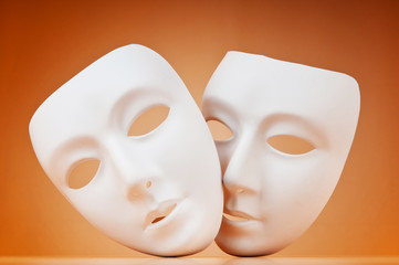 Theatre concept with masks against background