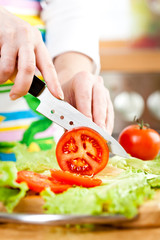 Woman's hands cutting vegetables