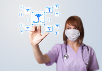 Woman doctor pressing digital button