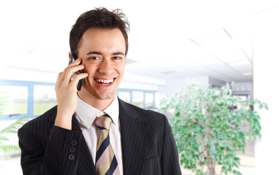 Young businessman talking at phone