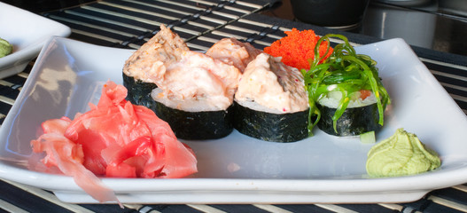 Assorted sushi plate on  plate over bamboo mat