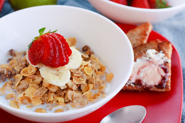 Cereal.  Flakes cereals with fresh strawberries and bananas.