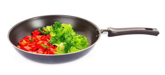 frying pan with vegetables  on white