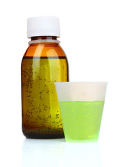 Cough medicine bottle  with poured dose on counter