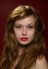 Fototapeta premium Portrait of attractive red-haired young girl with classical glam