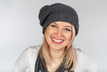 Stylish blonde girl in winter wool hat