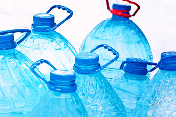 Rows of plastic water bottles with blue caps