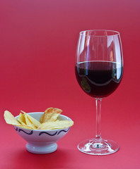 A glass of wine and chips