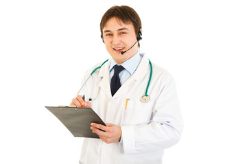 Smiling medical doctor with headset holding clipboard