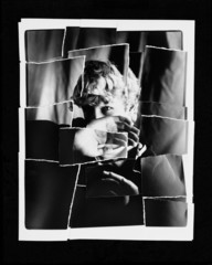 Torn Up Photo Of Child Blocking Face With Hand