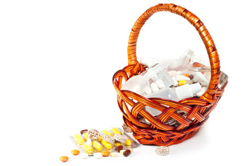 Fototapeta na wymiar pills and vitamins in brown basket